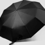 schwarzer Regenschirm mit Holzgriff