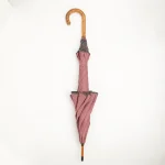 Dusty rose custom designer umbrella with scalloped canopy and wooden handle, closed view