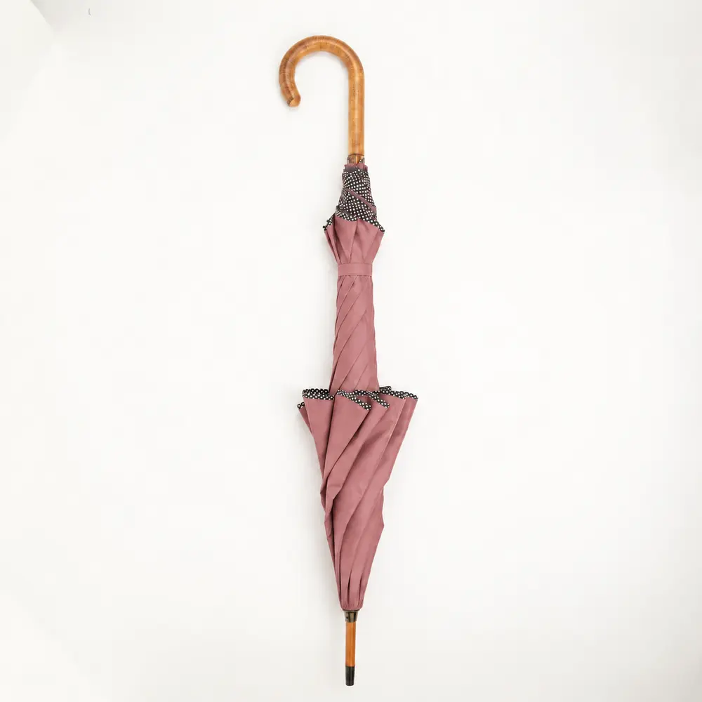 Dusty rose custom designer umbrella with scalloped canopy and wooden handle, closed view